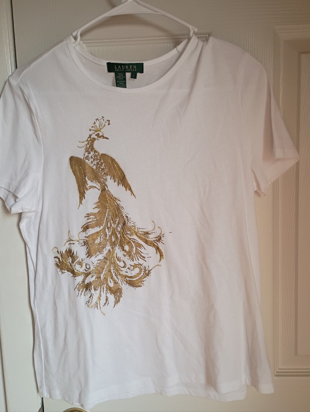 This is the Lauren Ralph Lauren white t-shirt featuring a gold metallic peacock